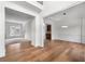 Open-concept living space with hardwood floors leading into a dining area, with bright natural light at 2310 Norbury Se Cv, Smyrna, GA 30080