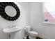Elegant powder room with pedestal sink and decorative mirror at 2310 Norbury Se Cv, Smyrna, GA 30080