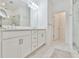 Bright bathroom with double sinks, glass shower, modern fixtures, and clean, white tile at 3313 Bartee Walk, Suwanee, GA 30024