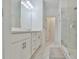 Modern bathroom featuring double sinks, a marble countertop, and a glass-enclosed shower at 3313 Bartee Walk, Suwanee, GA 30024