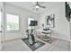 Bright bedroom featuring an exercise bike, modern desk, and neutral decor at 3313 Bartee Walk, Suwanee, GA 30024