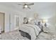 Cozy bedroom features neutral decor, soft lighting, and an adjacent bathroom for added convenience at 3313 Bartee Walk, Suwanee, GA 30024