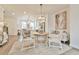 Dining room showcases decorative lighting, modern art, and seamless flow to kitchen at 3313 Bartee Walk, Suwanee, GA 30024