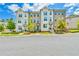 Townhome exteriors boast brick and painted facades with well-manicured landscaping and inviting entrances at 3313 Bartee Walk, Suwanee, GA 30024