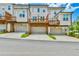 Townhome exterior with garages, wooden decks, and modern architectural design at 3313 Bartee Walk, Suwanee, GA 30024
