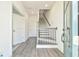 Bright foyer showcases a staircase with a modern railing and new hard surface flooring throughout at 3313 Bartee Walk, Suwanee, GA 30024