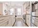 Bright kitchen features a large island, stainless steel appliances, and modern light fixtures at 3313 Bartee Walk, Suwanee, GA 30024