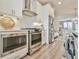 Updated kitchen with stainless steel appliances, white cabinets, and subway tile backsplash at 3313 Bartee Walk, Suwanee, GA 30024
