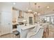 Open kitchen with quartz countertops, pendant lighting, and barstool seating at 3313 Bartee Walk, Suwanee, GA 30024