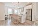 Island kitchen features stainless appliances, pendant lighting, and ample countertop space for cooking and entertaining at 3313 Bartee Walk, Suwanee, GA 30024