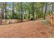 Large backyard with tall trees and a wooden fence at 410 Wilkinson Se Dr, Atlanta, GA 30317