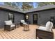 Relaxing backyard deck features comfortable seating around a modern fire pit at 410 Wilkinson Se Dr, Atlanta, GA 30317