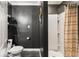 Modern bathroom features a tiled shower, dark walls, and sleek shelving for a contemporary aesthetic at 410 Wilkinson Se Dr, Atlanta, GA 30317