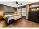 A cozy bedroom features dark walls, hardwood floors, a large bed, and a decorative dresser at 410 Wilkinson Se Dr, Atlanta, GA 30317