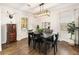 Bright dining room with a modern chandelier, hardwood floors, and windows with bright lighting at 410 Wilkinson Se Dr, Atlanta, GA 30317