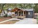 Charming renovated home boasts a welcoming front porch with exposed wood beams and modern railings at 410 Wilkinson Se Dr, Atlanta, GA 30317