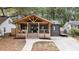 Charming home with a large, inviting covered front porch, steps, and walkway leading to the front door at 410 Wilkinson Se Dr, Atlanta, GA 30317