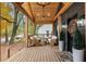 Cozy covered front porch with wooden beams, stylish seating, plants, and a ceiling fan at 410 Wilkinson Se Dr, Atlanta, GA 30317