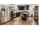 Modern kitchen with stainless steel appliances, dark cabinets, an island with bar stools, and hardwood floors at 410 Wilkinson Se Dr, Atlanta, GA 30317