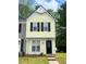 Charming two-story home with a yellow facade and black shutters, complemented by a well-maintained front lawn at 458 Prince Of Wales, Stone Mountain, GA 30083