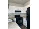 Efficient kitchen featuring white cabinets, sleek black appliances, and durable countertops at 458 Prince Of Wales, Stone Mountain, GA 30083