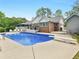 Beautiful backyard oasis with a sparkling pool, large patio, and lush landscaping at 8117 Spivey Rd, Jonesboro, GA 30236