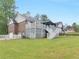Expansive backyard with lush green lawn, deck, and outdoor seating area at 8117 Spivey Rd, Jonesboro, GA 30236