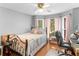 Cozy bedroom with hardwood floors, natural light, and neutral decor at 8117 Spivey Rd, Jonesboro, GA 30236