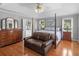 Spacious bedroom with a four-poster bed, sitting area, and hardwood floors at 8117 Spivey Rd, Jonesboro, GA 30236