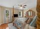 Bedroom with hardwood floors, four-poster bed, television and neutral decor at 8117 Spivey Rd, Jonesboro, GA 30236