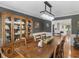 Bright dining room features hardwood floors, modern chandelier and a wooden cabinet at 8117 Spivey Rd, Jonesboro, GA 30236