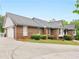 Side view of a brick home with a garage and a well-manicured lawn at 8117 Spivey Rd, Jonesboro, GA 30236