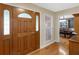 Foyer area with hardwood floors, wooden door, and a view to the dining area at 8117 Spivey Rd, Jonesboro, GA 30236
