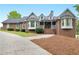Charming brick home with a well-manicured front yard and inviting front porch at 8117 Spivey Rd, Jonesboro, GA 30236