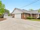 Side view of a brick home with a garage and a white picket fence at 8117 Spivey Rd, Jonesboro, GA 30236