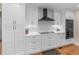 Well-appointed kitchen features white cabinets, modern appliances, and a black range hood at 8117 Spivey Rd, Jonesboro, GA 30236