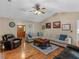 Inviting living room boasts a large sectional sofa, hardwood floors, and a charming ceiling fan at 8117 Spivey Rd, Jonesboro, GA 30236