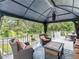 Inviting covered patio with wicker furniture and blue rug offering a relaxing outdoor living space at 8117 Spivey Rd, Jonesboro, GA 30236