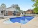 Inviting backyard pool and patio area with a diving board, perfect for summer fun at 8117 Spivey Rd, Jonesboro, GA 30236