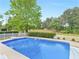 A refreshing pool with a diving board, surrounded by lush greenery and a white picket fence at 8117 Spivey Rd, Jonesboro, GA 30236