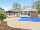 Backyard oasis with swimming pool, deck, and lounge chairs, perfect for summer relaxation at 8117 Spivey Rd, Jonesboro, GA 30236