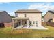 View of the backyard with a covered patio, grassy area, and fenced perimeter, ideal for outdoor activities at 109 Logan Pass Dr, Loganville, GA 30052