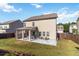 Backyard featuring a covered patio, well-maintained lawn, and a house at 109 Logan Pass Dr, Loganville, GA 30052