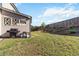 Spacious fenced backyard with lush lawn, mature landscaping, and an outdoor grill, perfect for entertaining and enjoying outdoor living at 109 Logan Pass Dr, Loganville, GA 30052