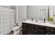 Well-lit bathroom with neutral tones, dark wood vanity, and white sink at 109 Logan Pass Dr, Loganville, GA 30052