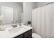 Bathroom featuring vanity with brushed nickel faucet and a white shower curtain at 109 Logan Pass Dr, Loganville, GA 30052