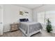 Bedroom boasts a plush bed, bedside table, house plant and a window that provides natural light at 109 Logan Pass Dr, Loganville, GA 30052