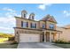 Charming two-story home featuring a brick facade, siding accents, and a spacious two-car garage at 109 Logan Pass Dr, Loganville, GA 30052
