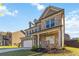 Attractive two-story home with a well-kept lawn, brick accents, and attached two-car garage at 109 Logan Pass Dr, Loganville, GA 30052