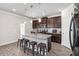 Modern kitchen features an island with barstool seating, stainless steel appliances, and sleek finishes at 109 Logan Pass Dr, Loganville, GA 30052